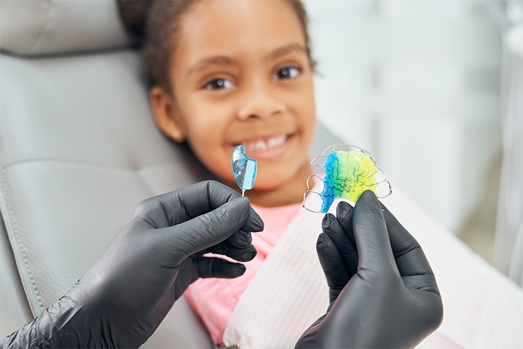 Child smiling during orthodontic consultation, showing how the best dental insurance in Toronto may cover braces for kids.