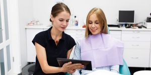 An orthodontist shows a likely outcome to the patient during the Invisalign consultation.